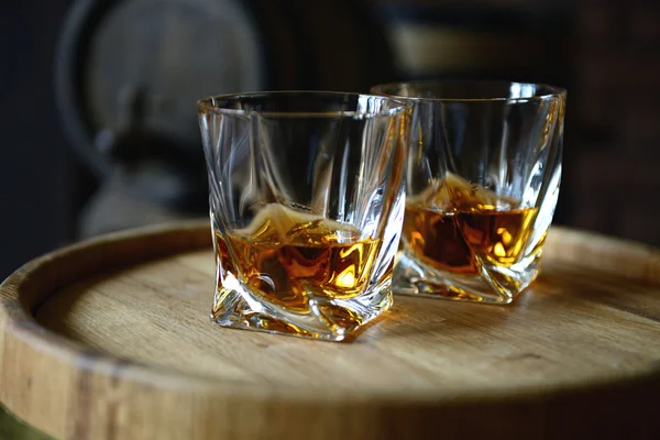 Glasses of brandy in cellar — Stock Photo, Image