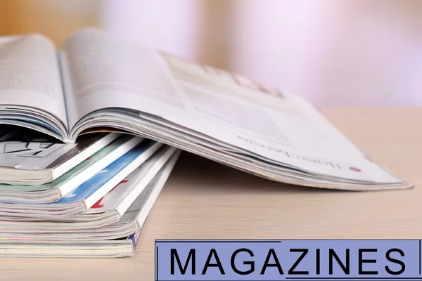 Magazines on wooden table, bright background — Stock Photo, Image