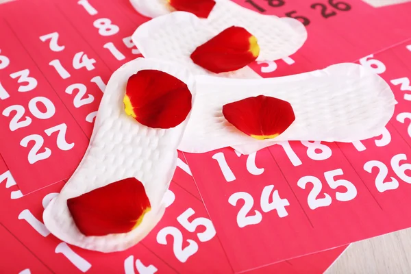 Sanitary pads and rose petals — Stock Photo, Image