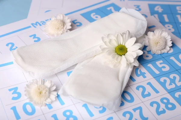 Sanitary pads and white flowers — Stock Photo, Image