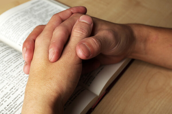 Male hands with Bible