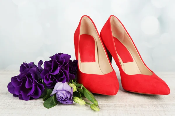 Beautiful woman shoes with flowers on bright background — Stock Photo, Image