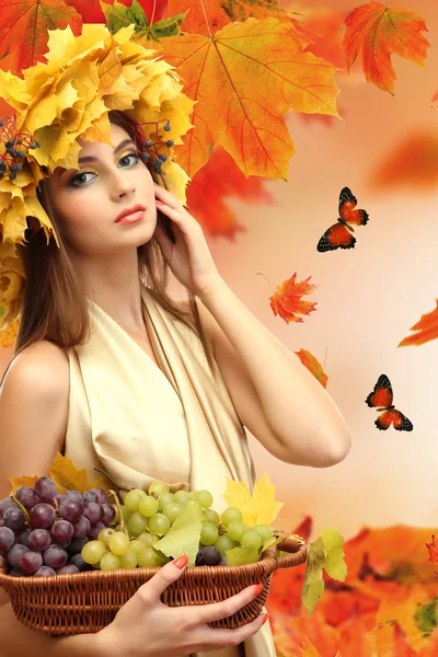 Beautiful young woman with yellow autumn wreath outdoors — Stock Photo, Image