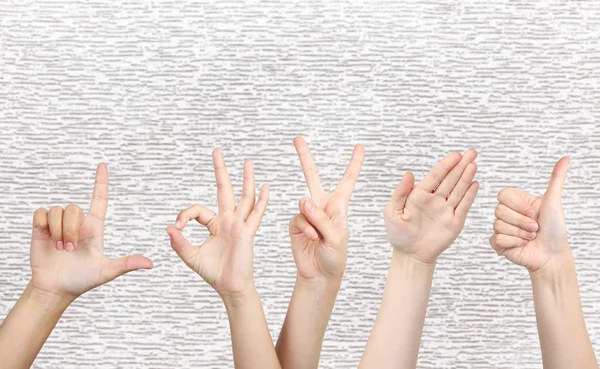 stock image Young people's hands on grey background