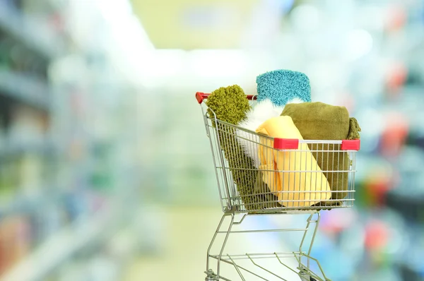 Shopping cart with colorful carpets — Stock Photo, Image