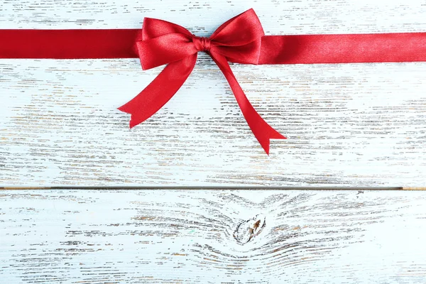 Old wooden background with beautiful bow — Stock Photo, Image