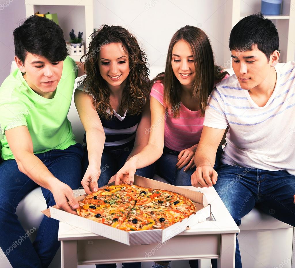 young friends eating pizza