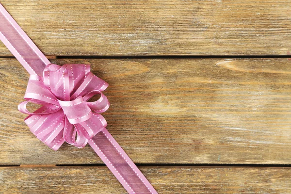 Old wooden background with beautiful bow — Stock Photo, Image