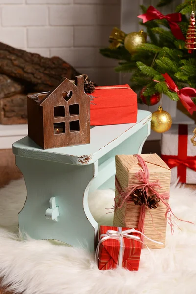 Christmas composition near fireplace in room — Stock Photo, Image