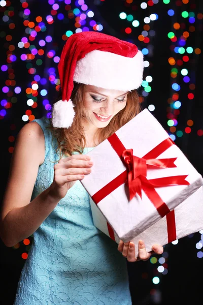 Portrait of beautiful young woman on bright lights background — Stock Photo, Image