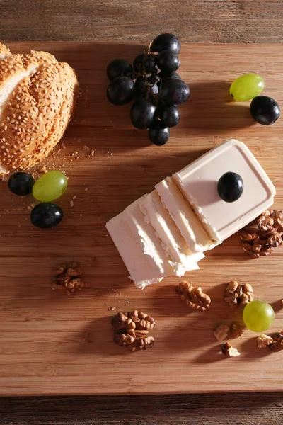 Still life with tasty cheese, grape and bread, close up — Stock Photo, Image