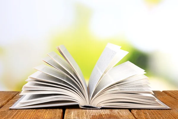 Open book on wooden table — Stock Photo, Image