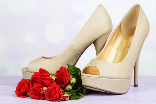 Beautiful woman shoes with flowers on bright background — Stock Photo, Image