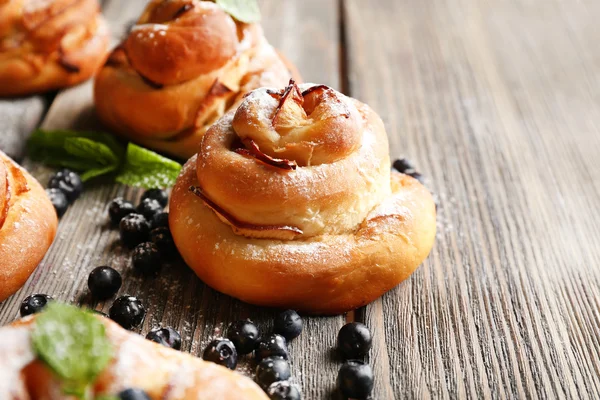 Tasty buns with berries on table close-up — Stock Photo, Image