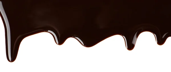 Melted chocolate dripping on white background — Stock Photo, Image