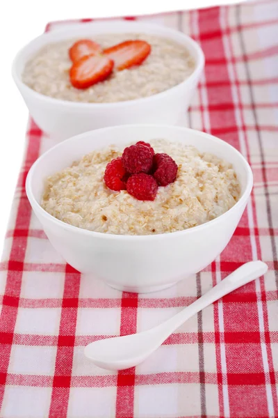 Tasty oatmeal with berries on napkin close-up — Stock Photo, Image