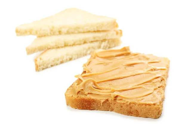 Creamy peanut butter and bread slices, isolated on white — Stock Photo, Image