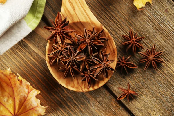 Stars anise in wooden spoon on table close up — Stock Photo, Image