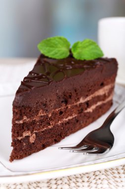 Doğal zemin üzerine ahşap masa üzerinde plaka üzerinde çikolatalı kek parçası