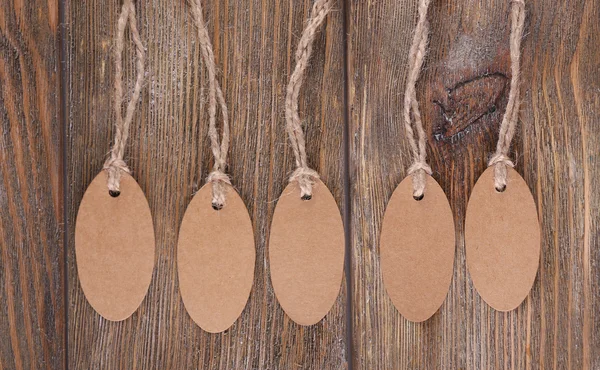 Brown tags on wooden background — Stock Photo, Image