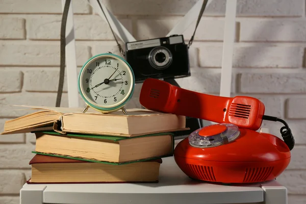 Old retro camera in composition with another retro things on wall background — Stock Photo, Image