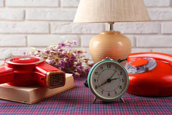 Retro things on table-hairdryer, clock, phone, book — Stock Photo, Image