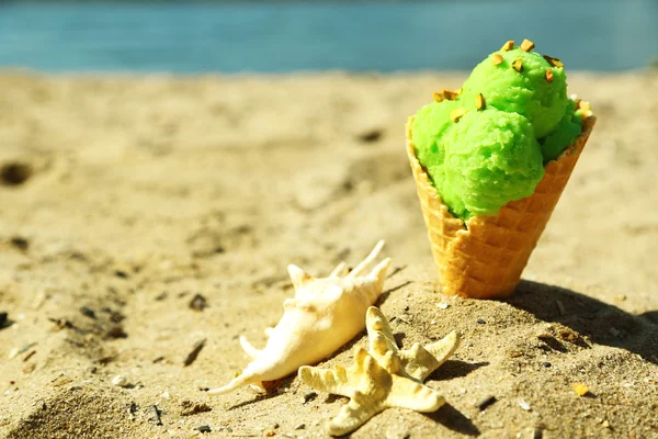 Ice cream in sand on beach — Stock Photo, Image