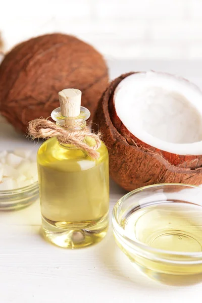 Coconut oil on table on light background — Stock Photo, Image