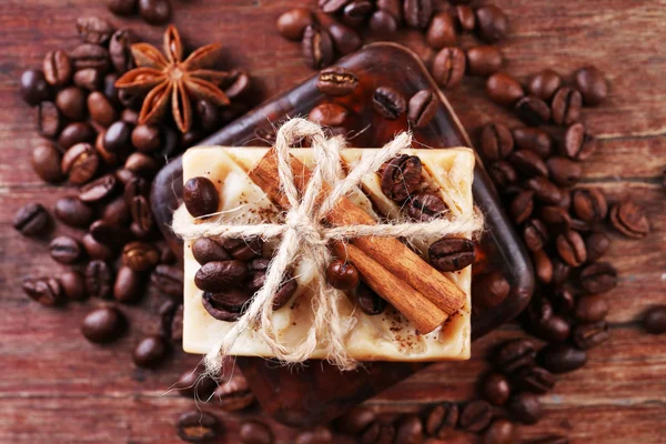 Organic soap with coffee beans and spices on wooden background — Stock Photo, Image