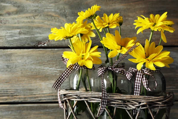 Beautiful chrysanthemum in vases on wooden background — Stock Photo, Image