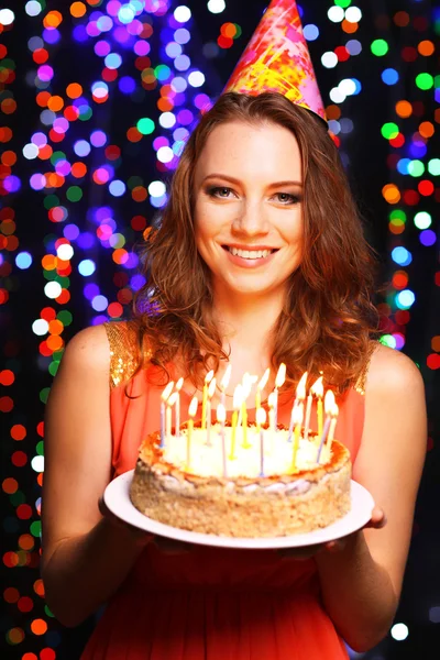 Portrait of beautiful young girl on bright lights background — Stock Photo, Image