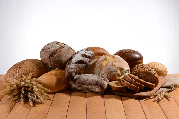 Fresh bread on table on white background — Stock Photo, Image