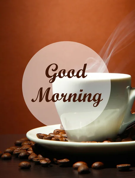 Cup of coffee with beans on table, on brown background — Stock Photo, Image