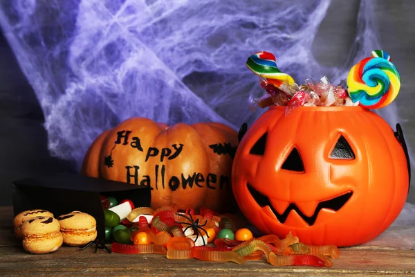 Composição para Halloween com doces na mesa de madeira — Fotografia de Stock