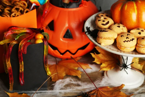 Halloween with sweets on wooden table — Stock Photo, Image