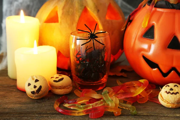 Halloween with sweets on wooden table Royalty Free Stock Photos
