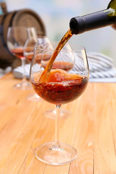 Red wine pouring into glass — Stock Photo, Image