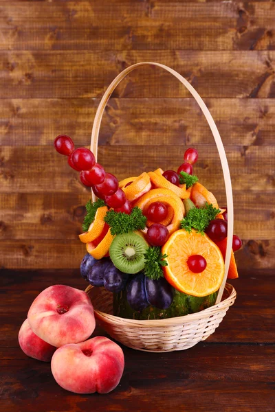 Table decoration made of fruits on wooden table on wooden wall background — Stock Photo, Image
