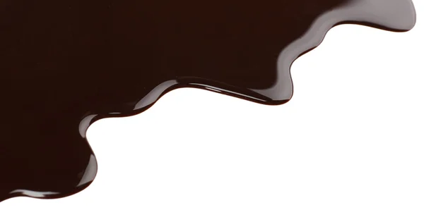 Melted chocolate dripping on white background — Stock Photo, Image