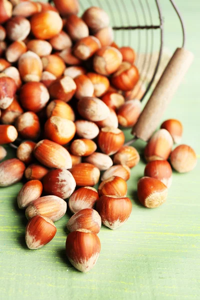 Hazelnuts in basket on wooden background — Stock Photo, Image