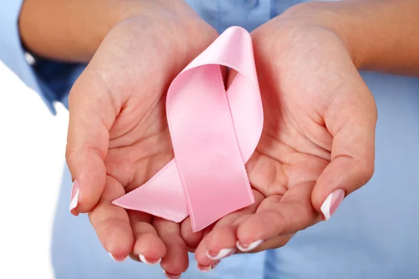 Woman with aids awareness pink ribbon in hands, close-up — Stock Photo, Image