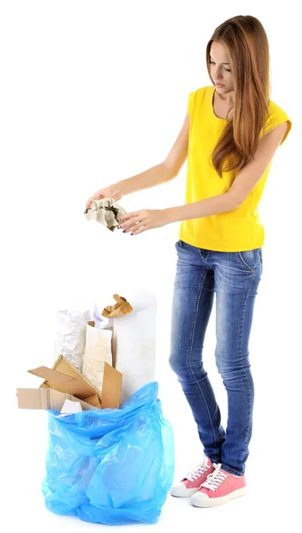 Young girl sorting paper and cardboard isolated on white — Stock Photo, Image