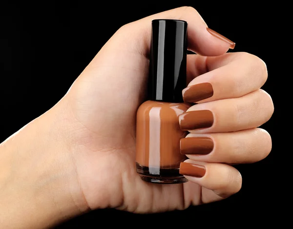 Nail polish in hand, close-up — Stock Photo, Image