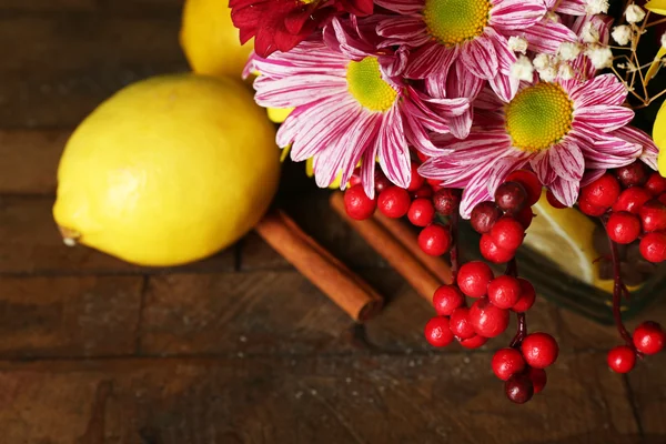 Piękne chryzantemy i cytryny na drewniane tła — Zdjęcie stockowe