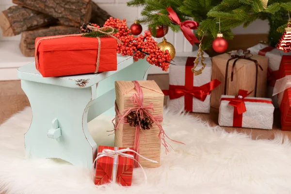 Christmas composition near fireplace in room — Stock Photo, Image