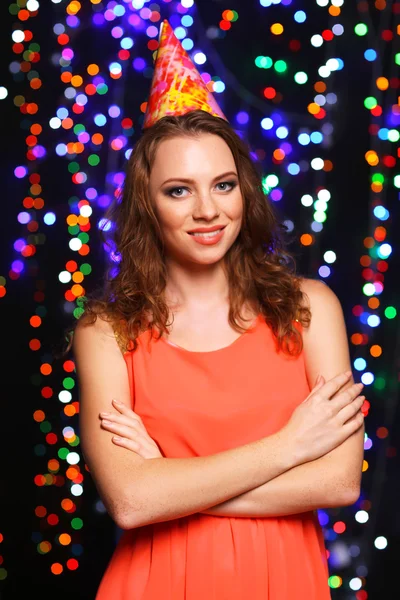 Portrait of beautiful young girl on bright lights background — Stock Photo, Image