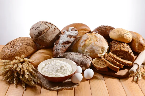 Pão fresco na mesa no fundo branco — Fotografia de Stock