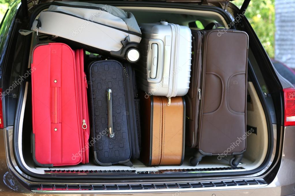 Suitcases and bags in trunk of car ready to depart for holidays — Stock