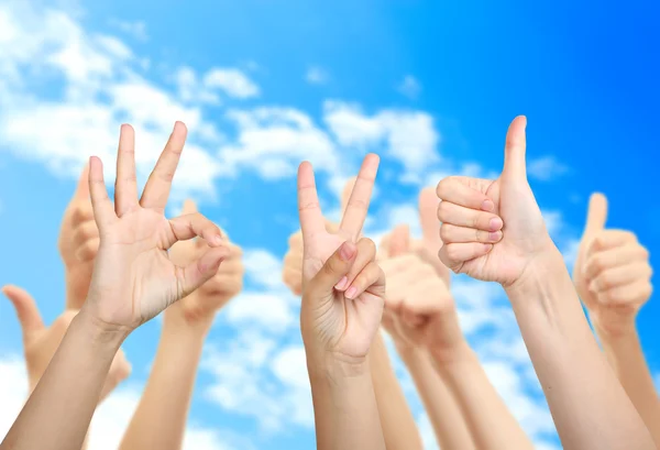 Young people's hands on sky background — Stock Photo, Image