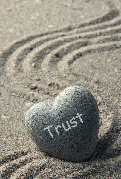 Grey zen stone in shape of heart, on sand background — Stock Photo, Image